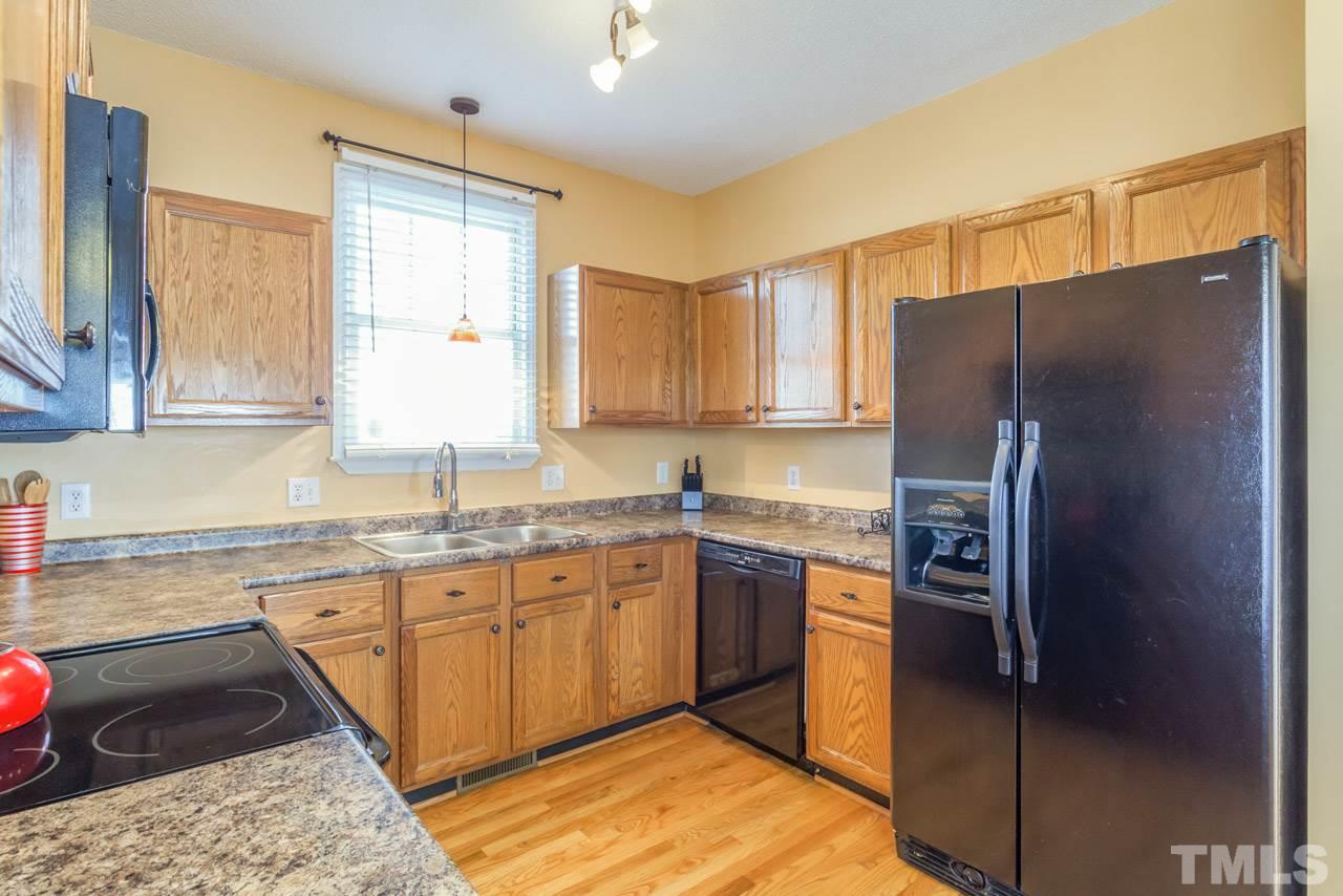 4601 Atterbury Court Raleigh, NC 27604 - Photo 4 of 25 a kitchen with stainless steel appliances granite countertop a refrigerator and a sink