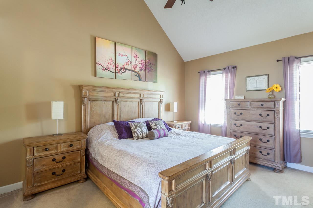 4601 Atterbury Court Raleigh, NC 27604 - Photo 5 of 25 a bedroom with a bed and a dresser