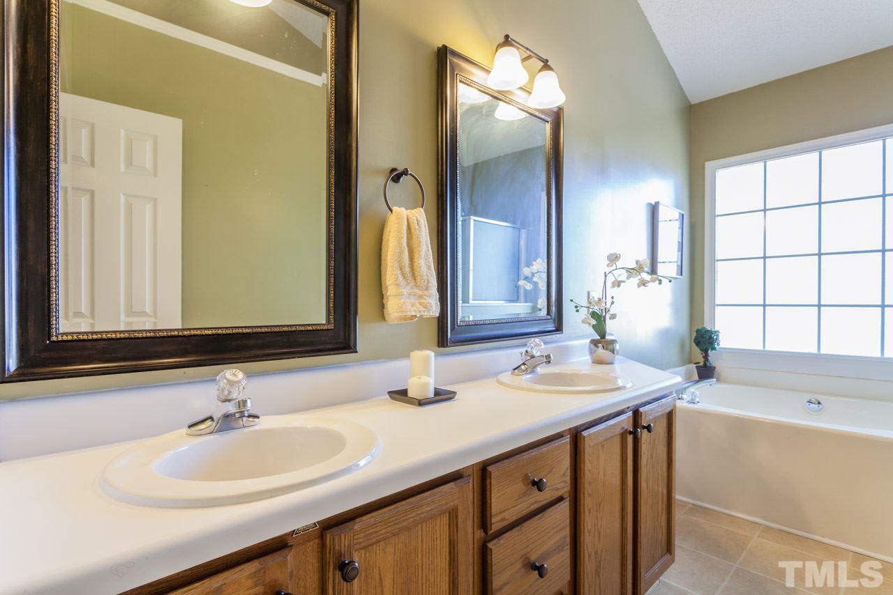 4601 Atterbury Court Raleigh, NC 27604 - Photo 6 of 25 a bathroom with a sink and a mirror