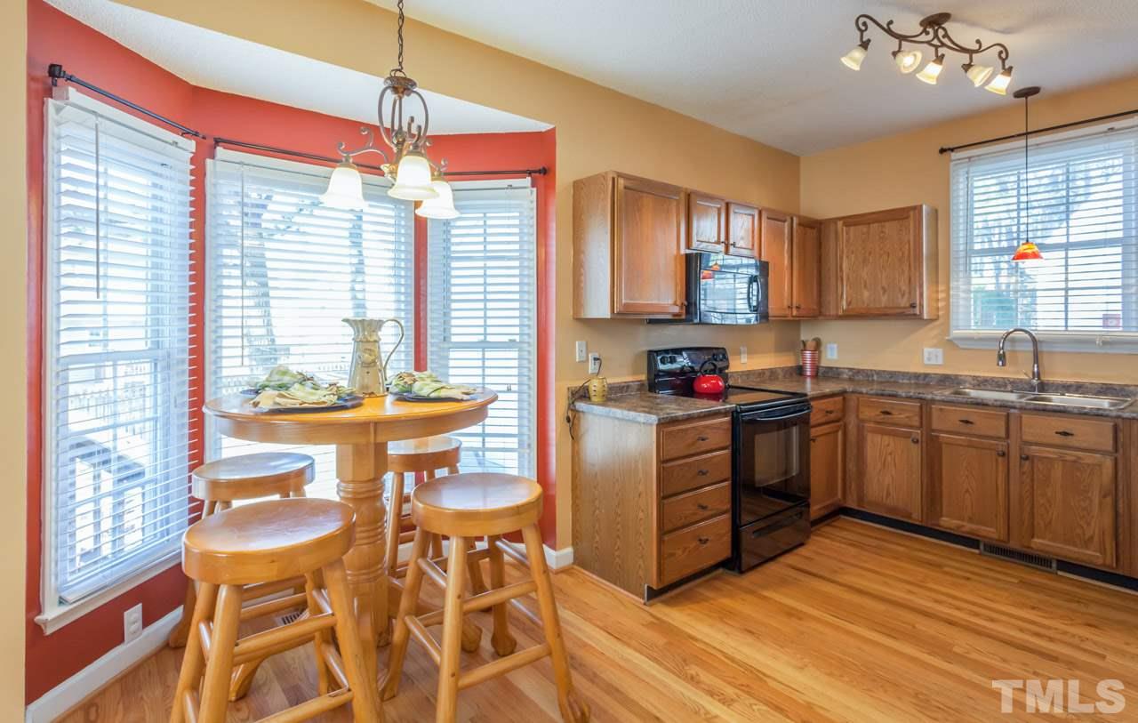 4601 Atterbury Court Raleigh, NC 27604 - Photo 7 of 25 a kitchen with a sink stove and cabinets