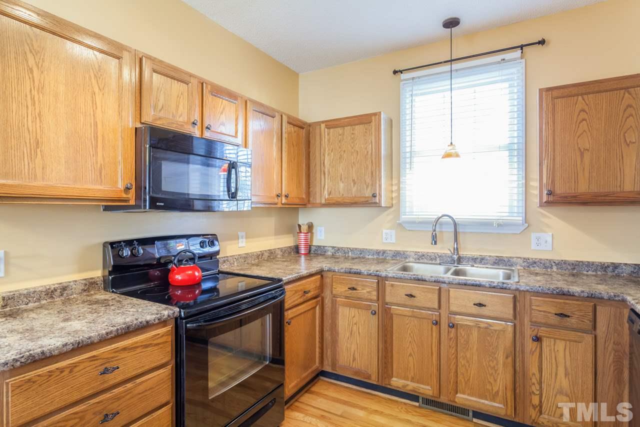 4601 Atterbury Court Raleigh, NC 27604 - Photo 8 of 25 a kitchen with stainless steel appliances granite countertop a sink stove and cabinets