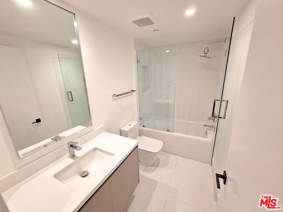 8326 Blackburn Avenue, Unit 204 Los Angeles, CA 90048 - Photo 12 of 17 a bathroom with a sink a toilet and shower