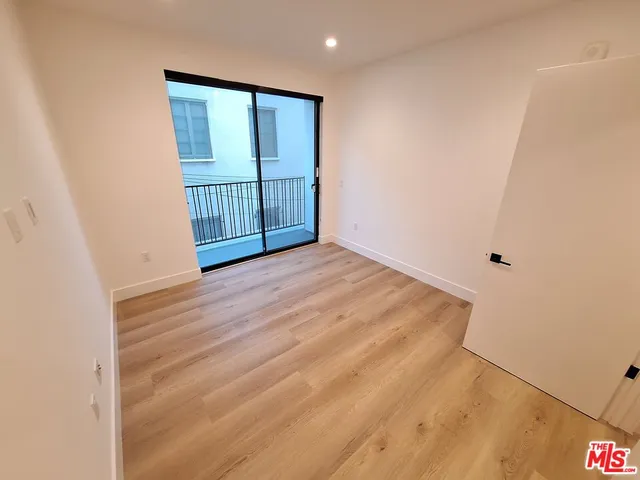 a view of a room with wooden floor and bathroom