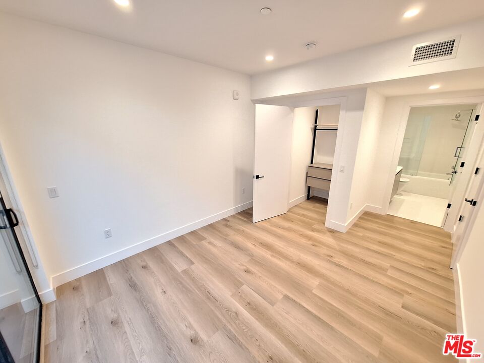 8326 Blackburn Avenue, Unit 204 Los Angeles, CA 90048 - Photo 10 of 17 a view of a room with wooden floor and bathroom