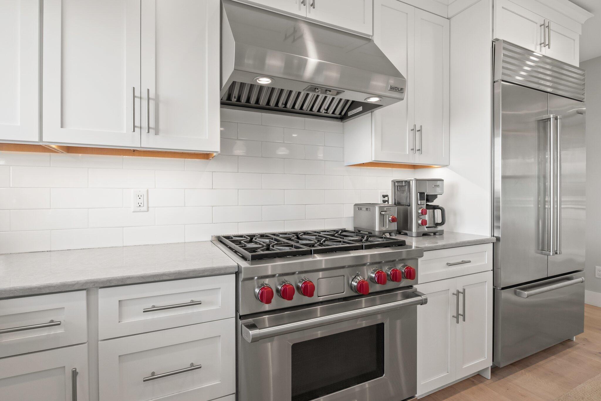 20 4th Avenue Wellfleet, MA 02667 - Photo 11 of 68 a kitchen with stainless steel appliances granite countertop a stove and a wooden cabinets