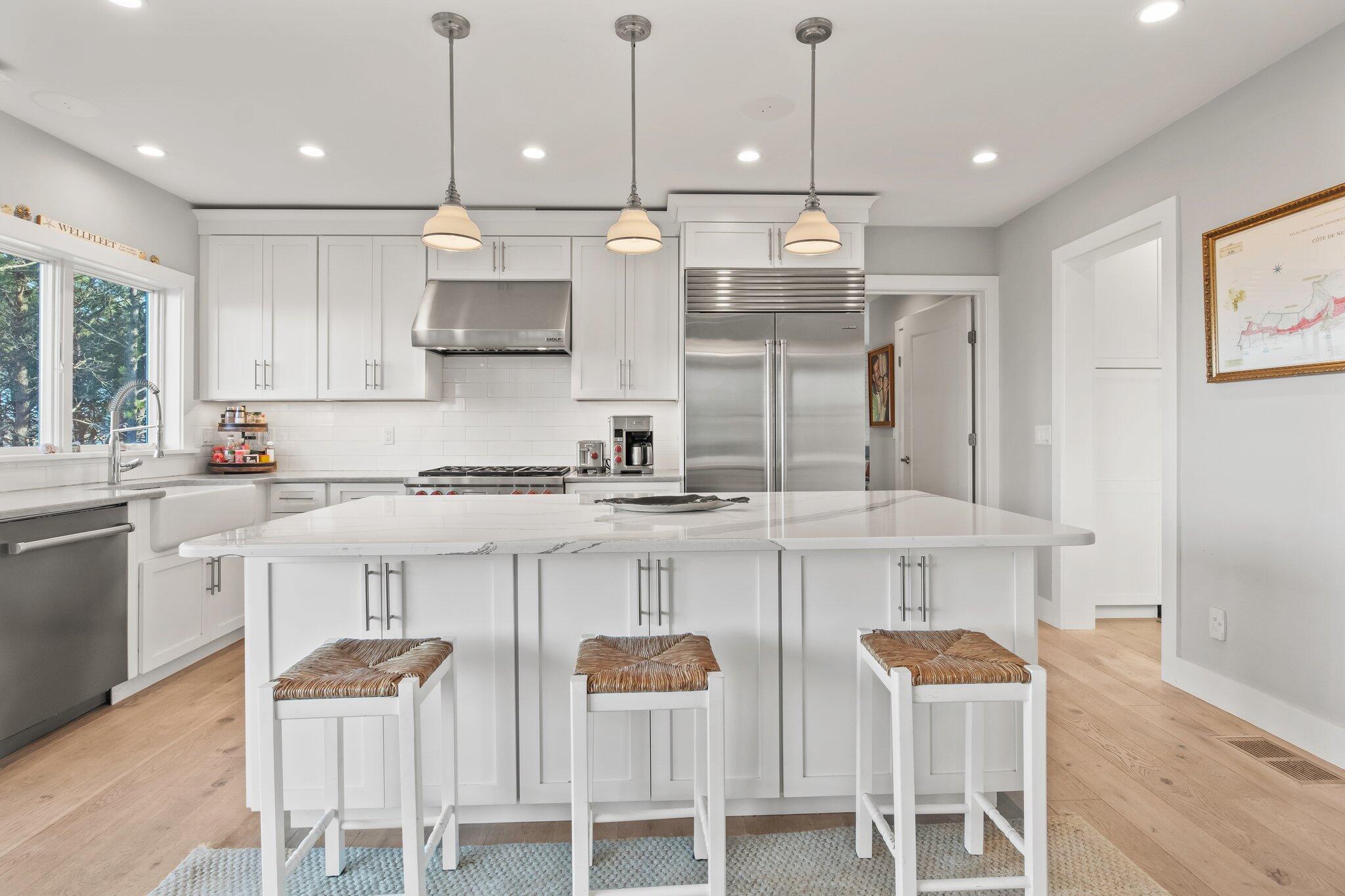 20 4th Avenue Wellfleet, MA 02667 - Photo 14 of 68 a kitchen with stainless steel appliances granite countertop a sink a stove a refrigerator and island with wooden floor