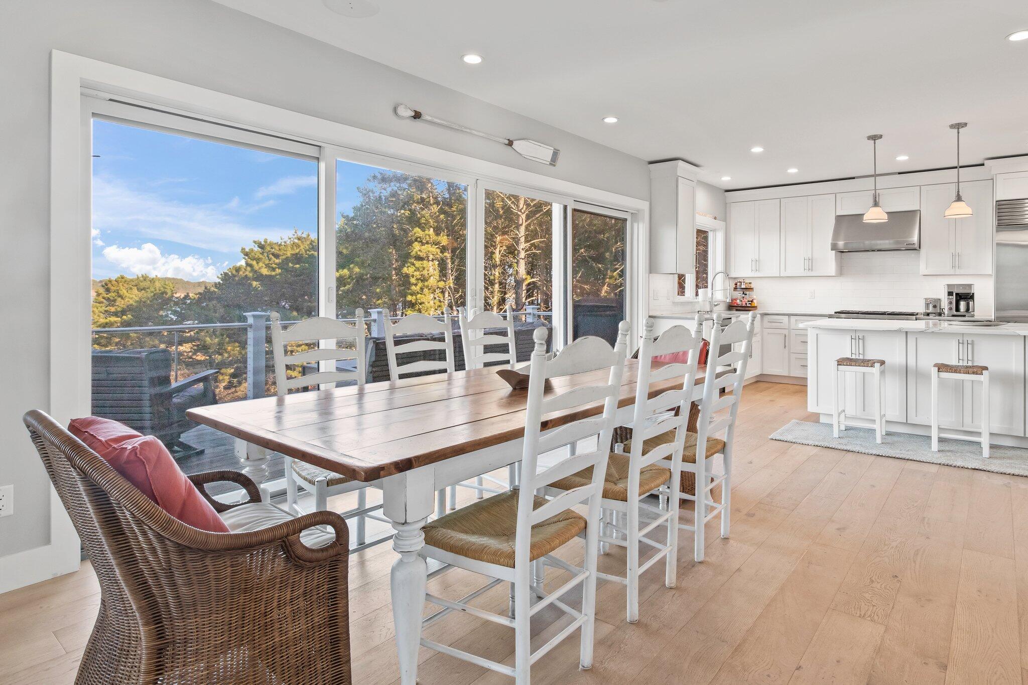 20 4th Avenue Wellfleet, MA 02667 - Photo 15 of 68 a dining room with furniture a chandelier and a floor to ceiling window