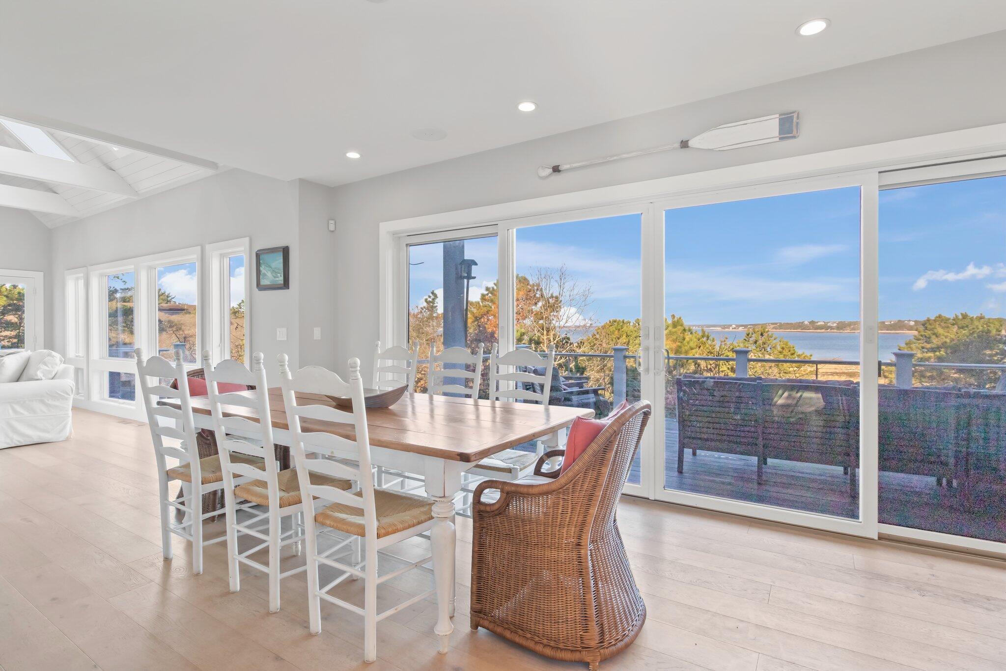 20 4th Avenue Wellfleet, MA 02667 - Photo 16 of 68 a dining room with furniture a chandelier and wooden floor