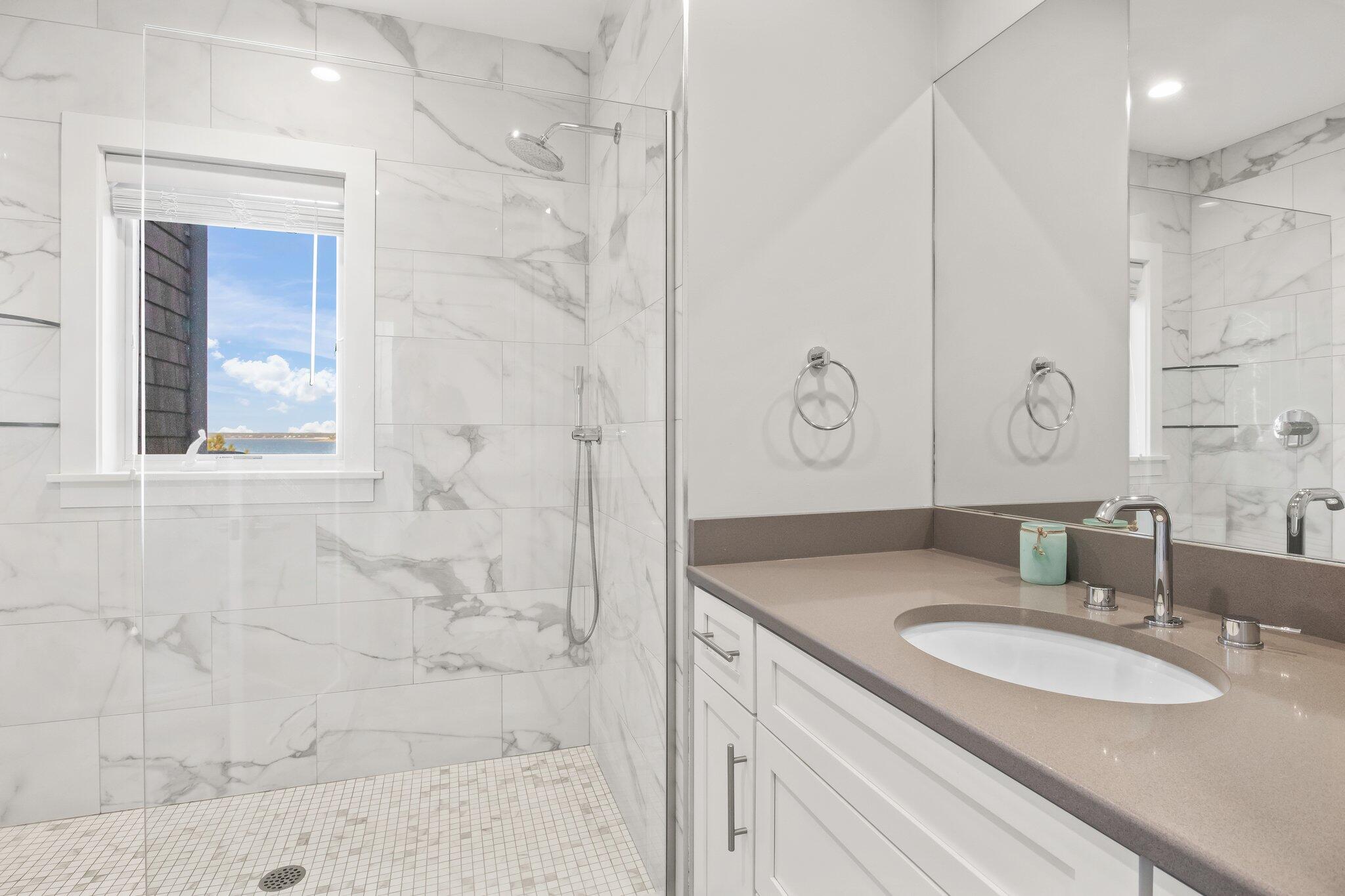 20 4th Avenue Wellfleet, MA 02667 - Photo 17 of 68 a bathroom with a granite countertop sink a mirror and shower
