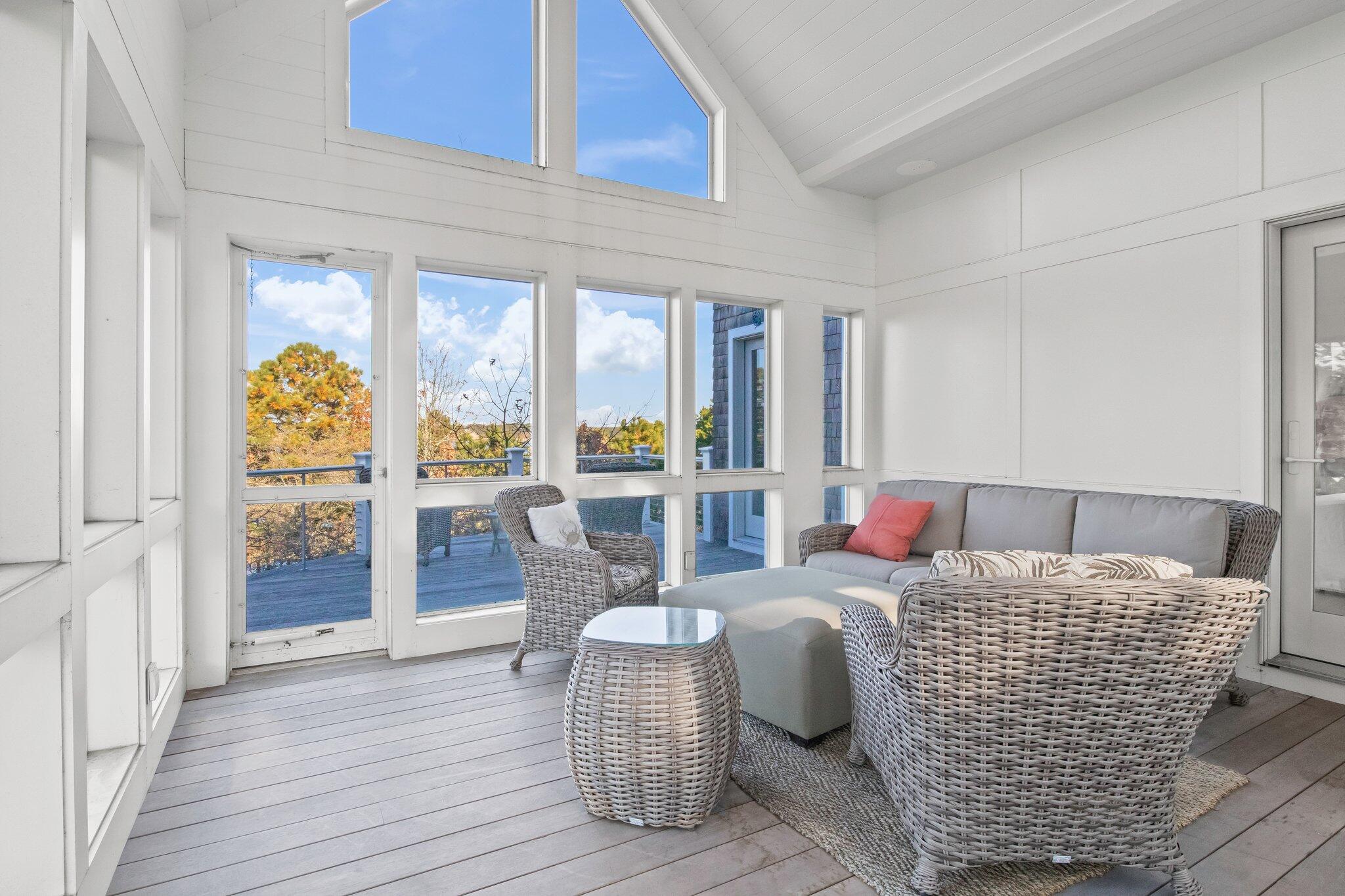 20 4th Avenue Wellfleet, MA 02667 - Photo 22 of 68 a living room with furniture floor to ceiling window and wooden floor