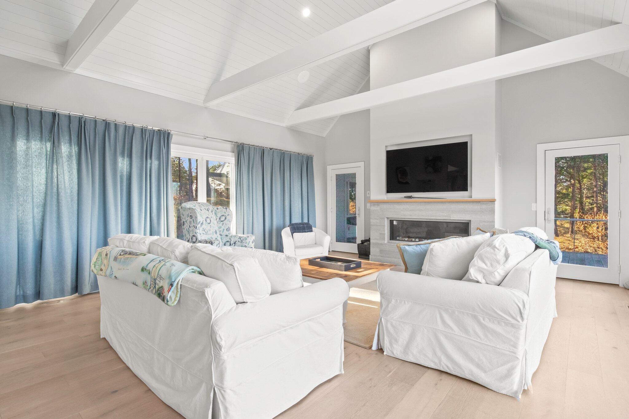 20 4th Avenue Wellfleet, MA 02667 - Photo 23 of 68 a living room with furniture fireplace and flat screen tv