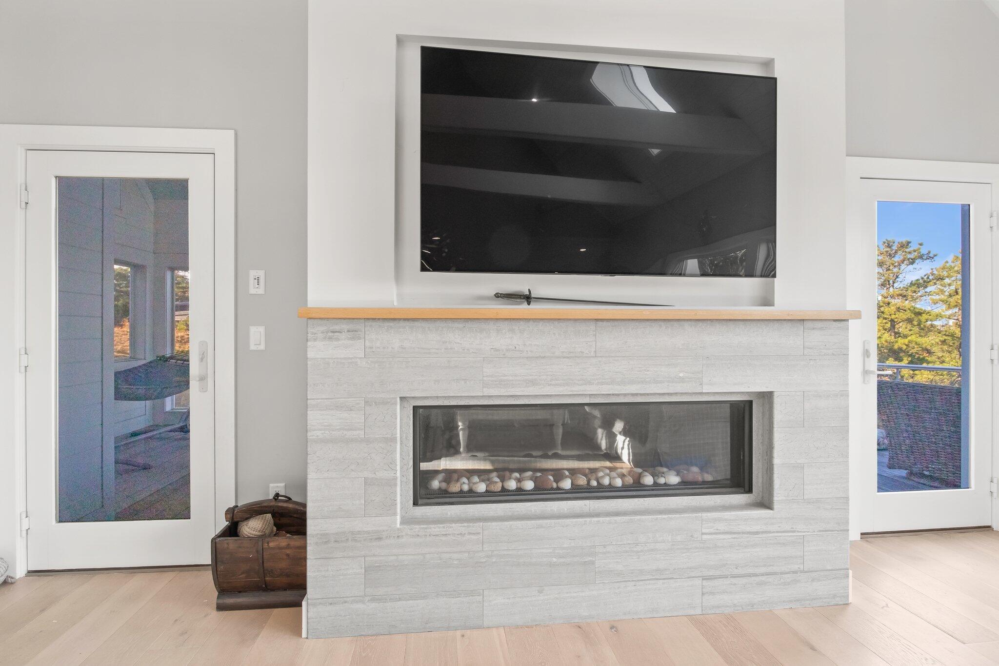 20 4th Avenue Wellfleet, MA 02667 - Photo 25 of 68 a living room with a fireplace and a potted plant