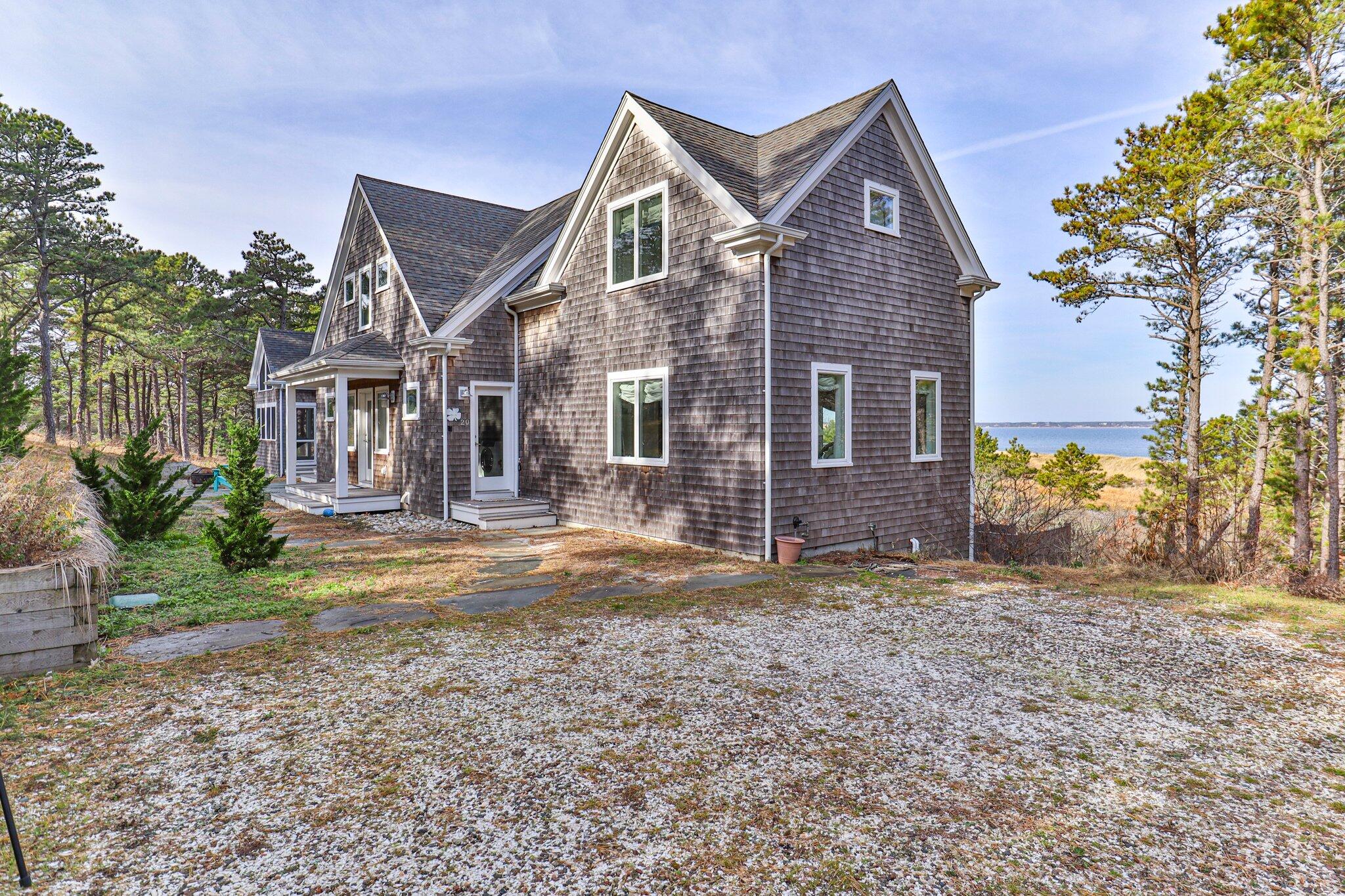 20 4th Avenue Wellfleet, MA 02667 - Photo 3 of 68 a front view of a house with a yard