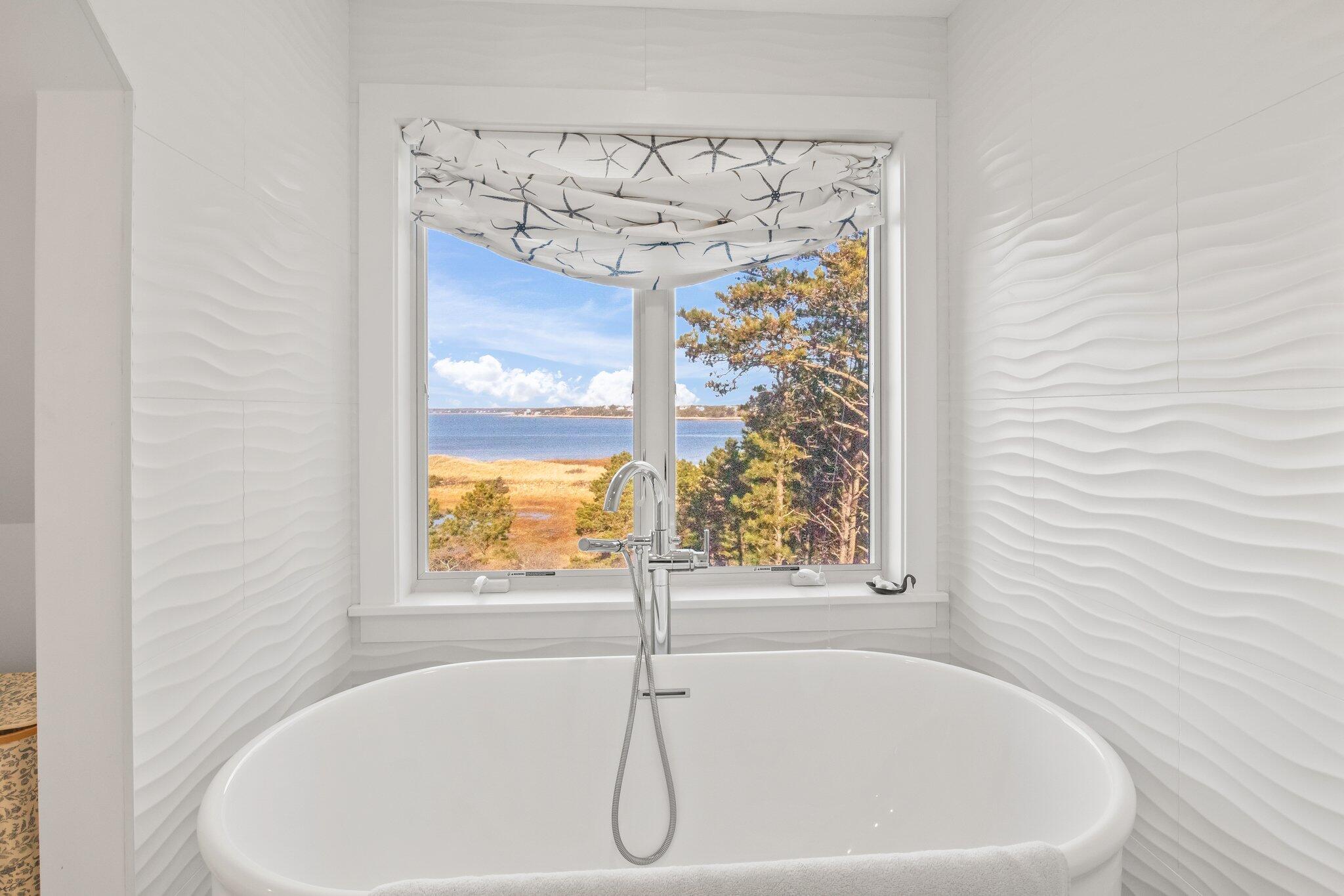 20 4th Avenue Wellfleet, MA 02667 - Photo 34 of 68 a white bath tub sitting next to a window