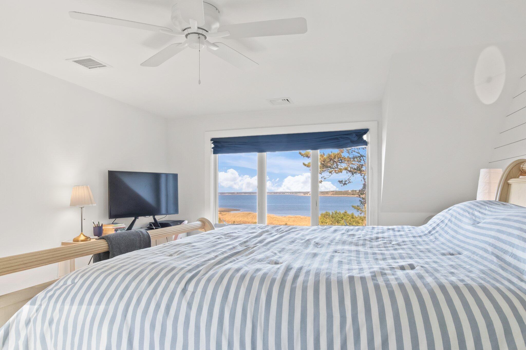 20 4th Avenue Wellfleet, MA 02667 - Photo 36 of 68 a bedroom with a large bed and a flat tv screen