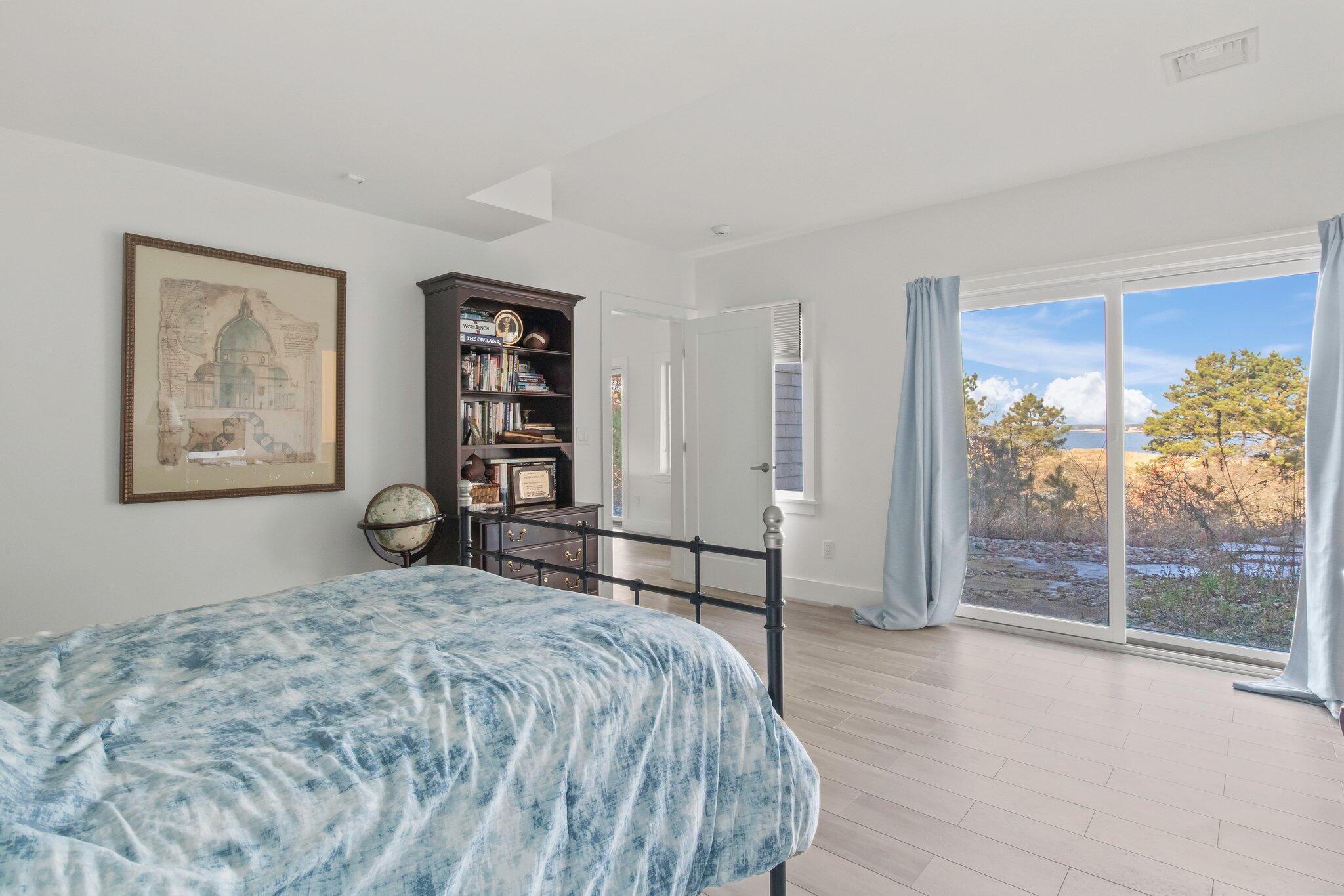 20 4th Avenue Wellfleet, MA 02667 - Photo 43 of 68 a spacious bedroom with a large bed and a large window
