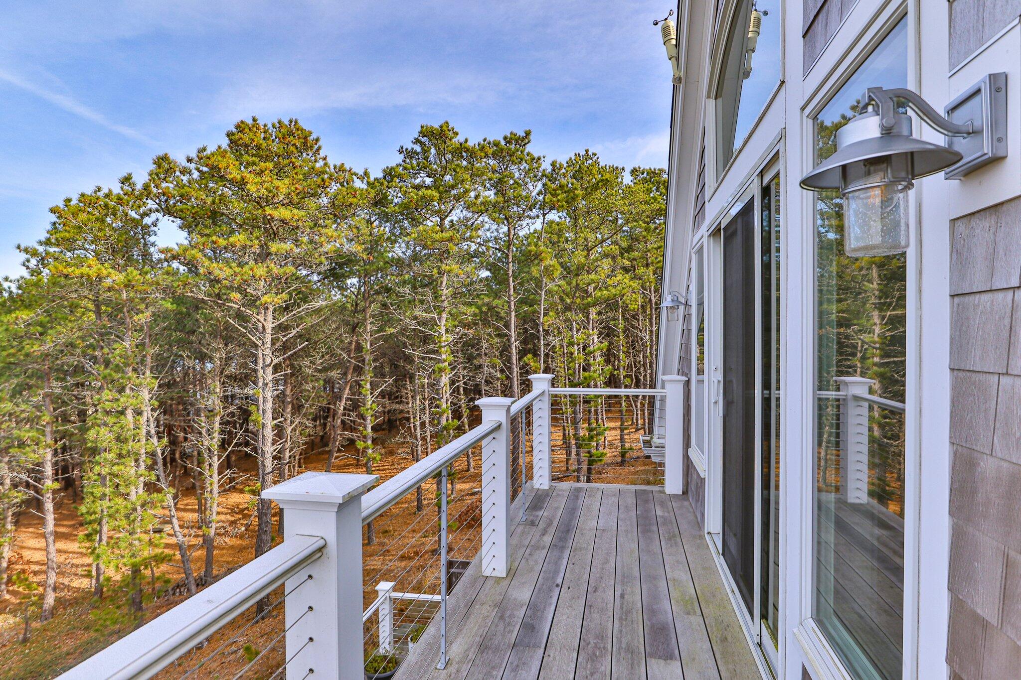 20 4th Avenue Wellfleet, MA 02667 - Photo 54 of 68 a view of a balcony with wooden floor and fence