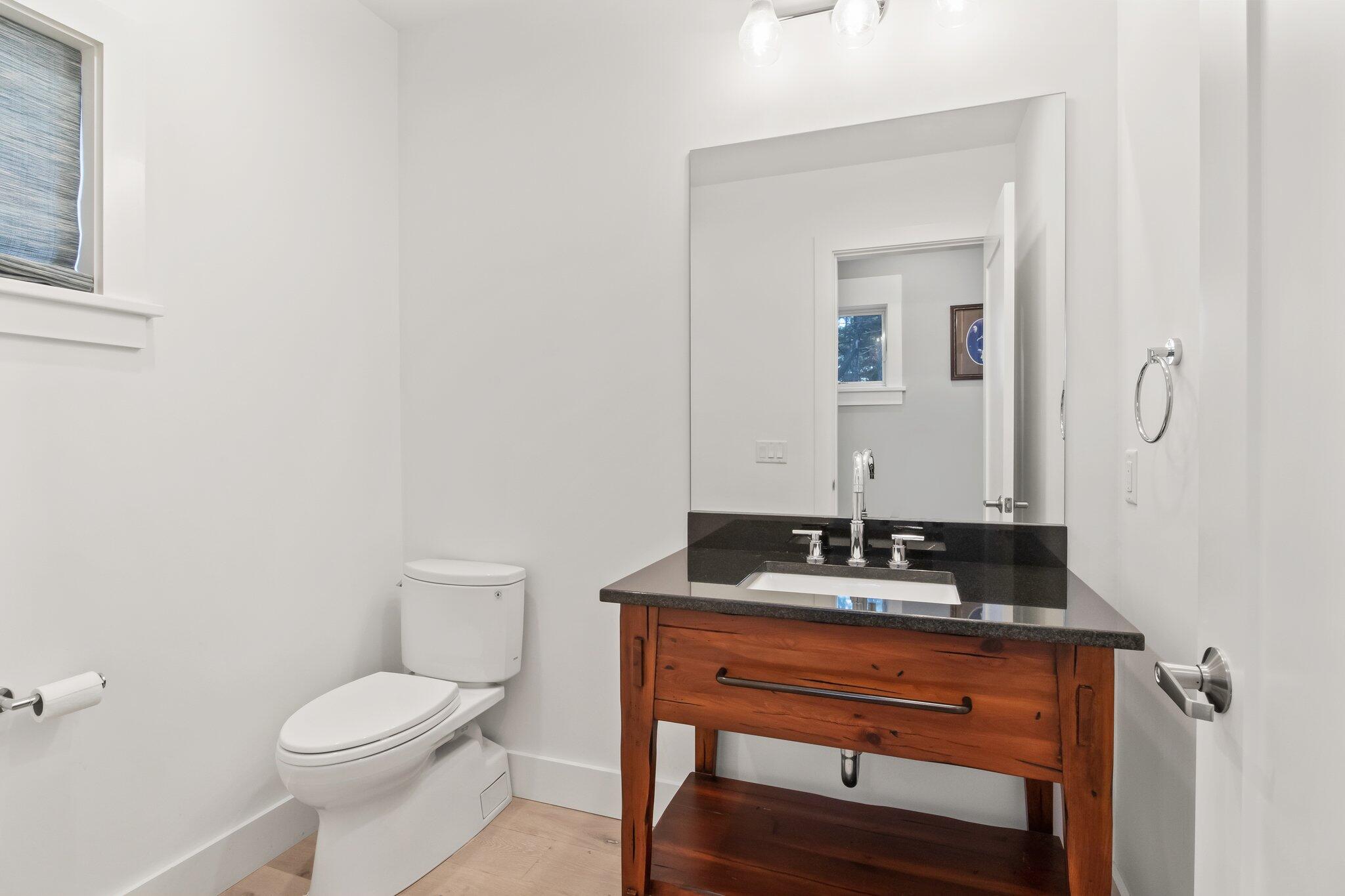 20 4th Avenue Wellfleet, MA 02667 - Photo 8 of 68 a bathroom with a granite countertop sink and a mirror with toilet