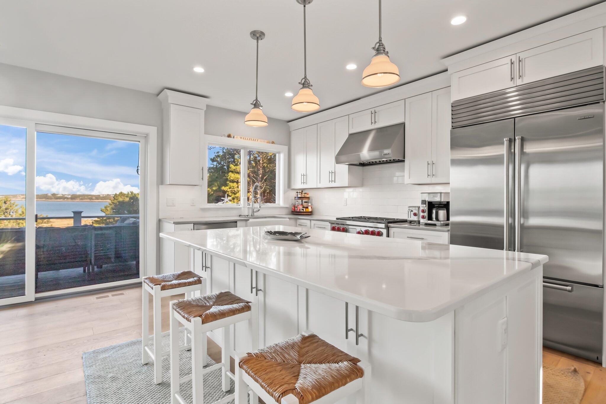 20 4th Avenue Wellfleet, MA 02667 - Photo 9 of 68 a kitchen with stainless steel appliances granite countertop a stove a sink and a refrigerator