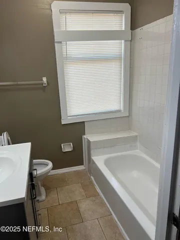 a bathroom with a toilet and a bathtub