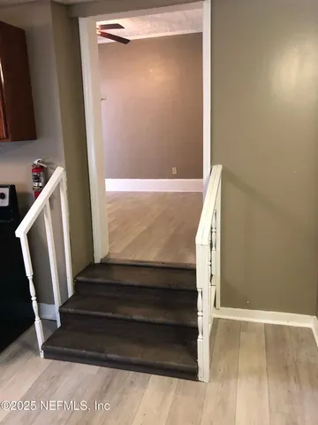 a white toilet sitting next to a bath tub