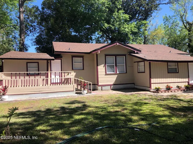 a front view of a house with a garden