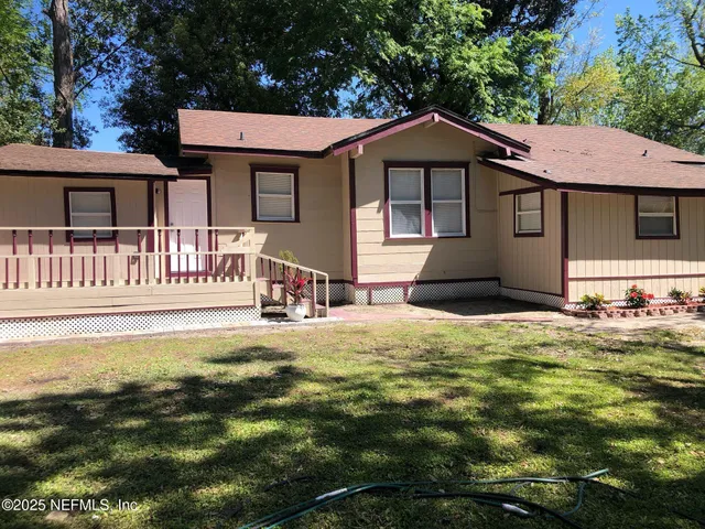 a view of balcony with wooden floor and fence