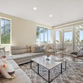 a living room with furniture and floor to ceiling windows