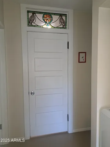 a view of utility room with closet and wooden floor