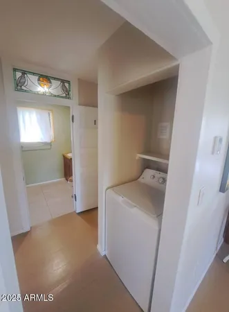a view of a hallway with wooden floor and closet