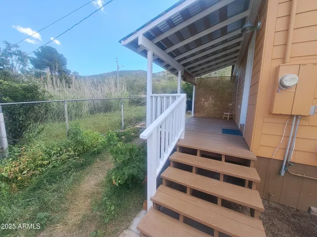 a view of a house with backyard and sitting area