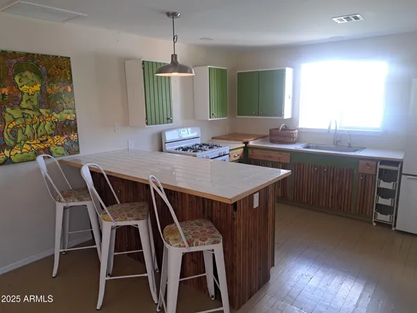 a kitchen with a table chairs sink and microwave