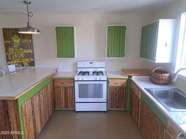 a kitchen with a sink and a stove top oven