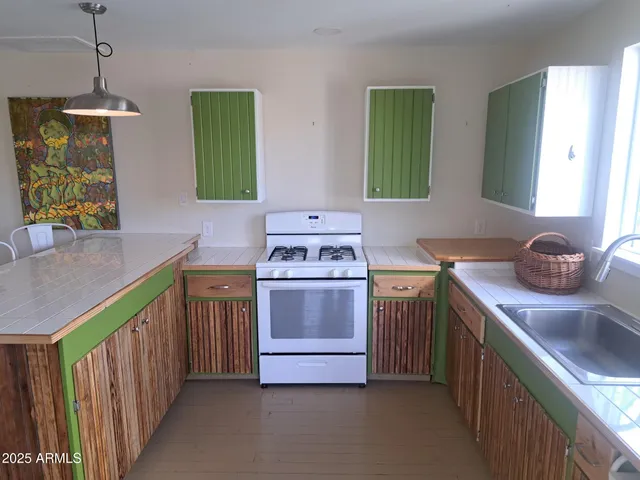 a kitchen with a sink and a stove top oven