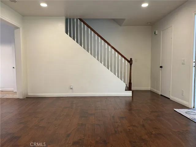 a view of an entryway with wooden floor