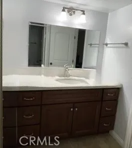 a bathroom with a sink vanity and a mirror