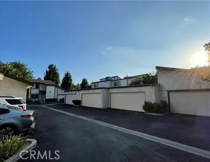 a view of a street with cars parked