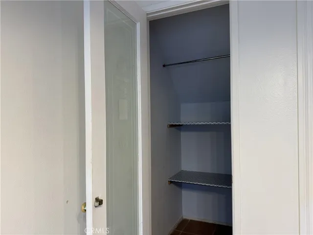 a view of walk in closet with empty racks