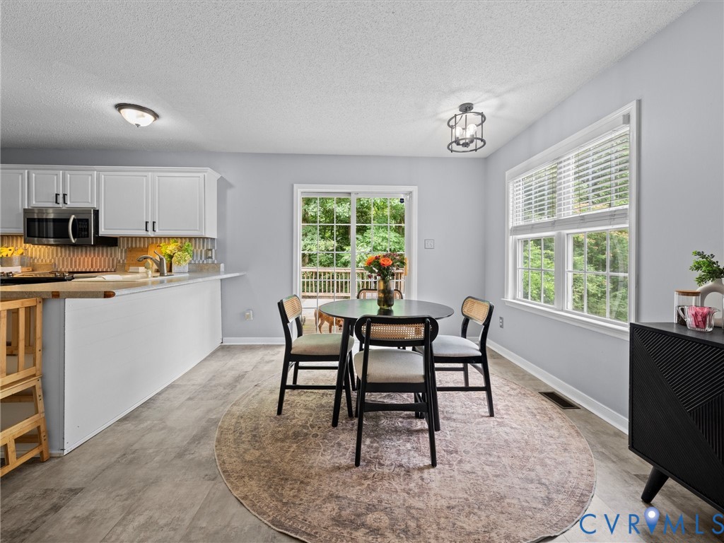 6712 Hedges Road Richmond, VA 23224 - Photo 9 of 34 Eat-in kitchen featuring wood-finish flooring, whi