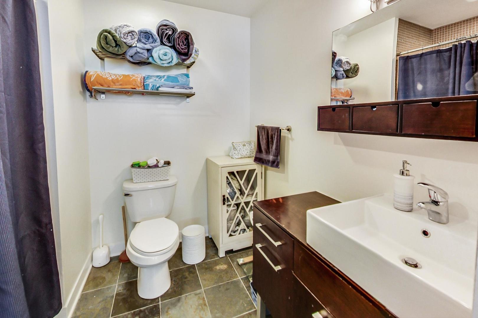 660 West Wayman Street, Unit 603 Chicago, IL 60661 - Photo 12 of 31 a bathroom with a sink a toilet and a mirror