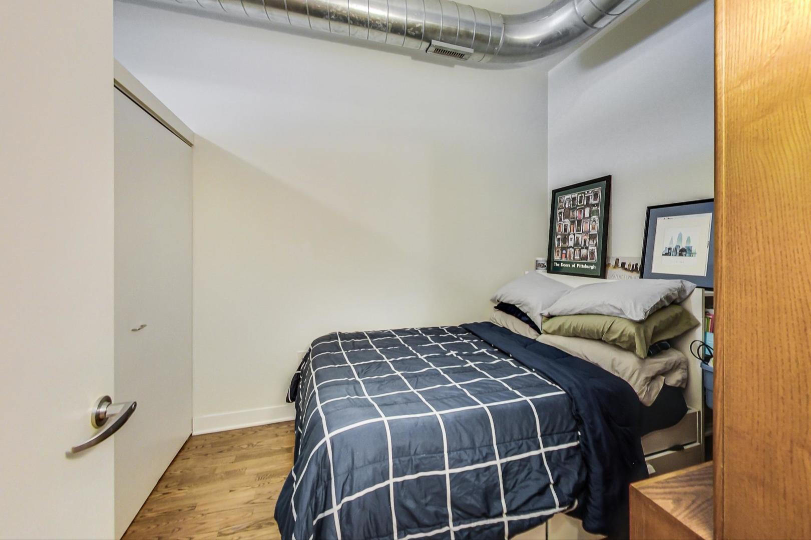 660 West Wayman Street, Unit 603 Chicago, IL 60661 - Photo 13 of 31 a bedroom with a bed and painting on the wall