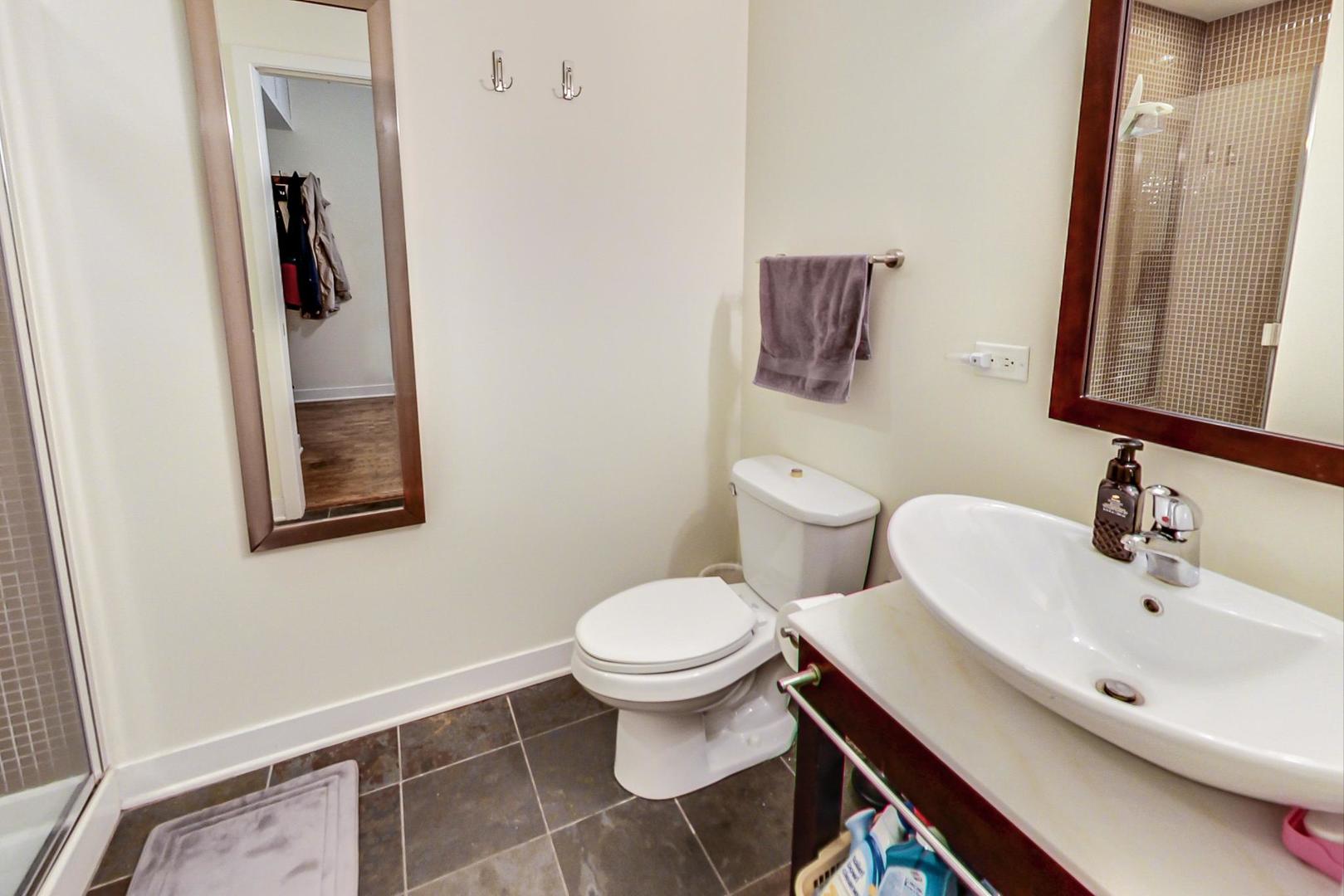 660 West Wayman Street, Unit 603 Chicago, IL 60661 - Photo 15 of 31 a bathroom with a toilet sink and mirror