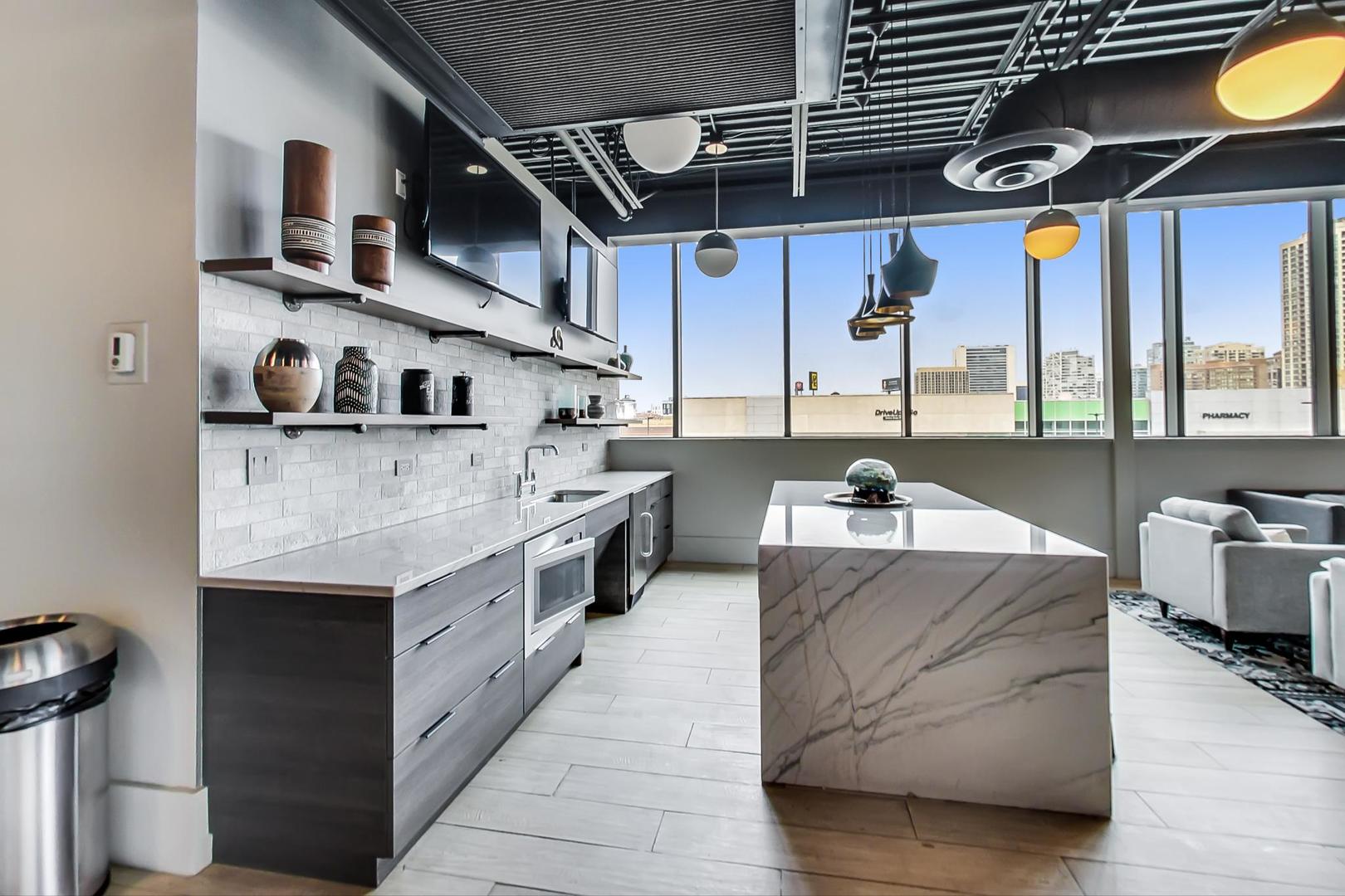 660 West Wayman Street, Unit 603 Chicago, IL 60661 - Photo 28 of 31 a large kitchen with stainless steel appliances granite countertop a lot of cabinets and wooden floor