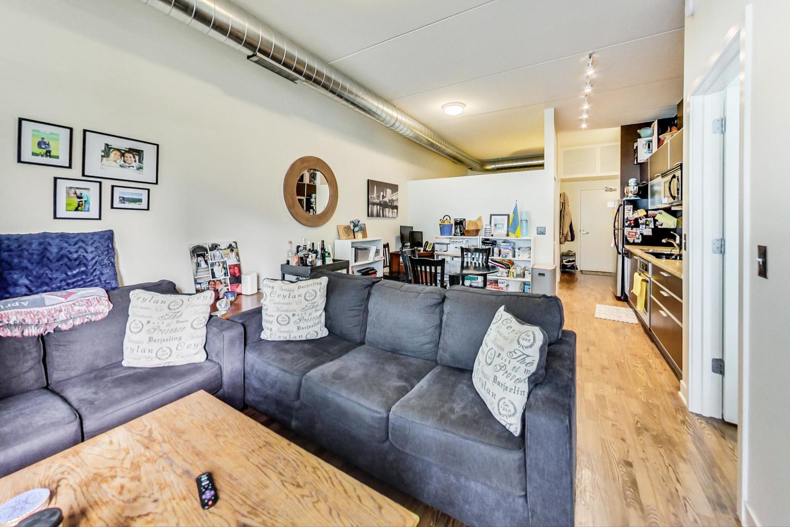 660 West Wayman Street, Unit 603 Chicago, IL 60661 - Photo 3 of 31 a living room with furniture and a wooden floor