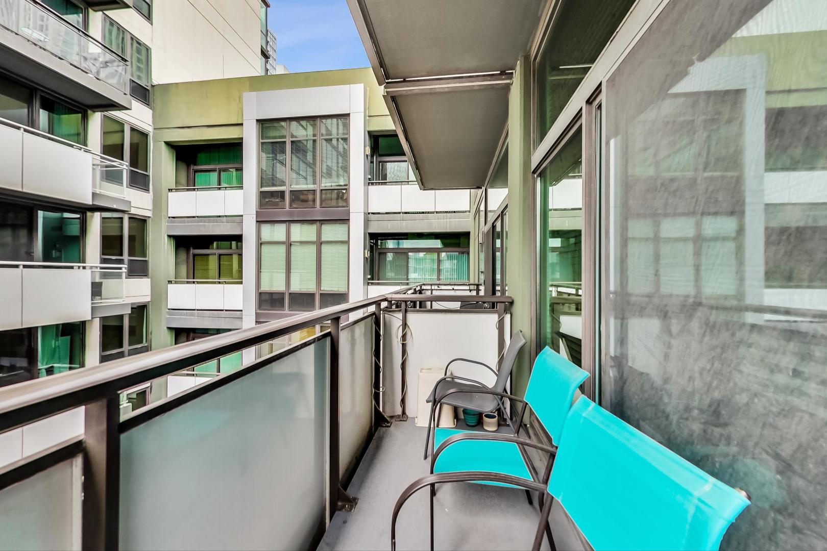 660 West Wayman Street, Unit 603 Chicago, IL 60661 - Photo 4 of 31 a view of a balcony with chairs and floor to ceiling window