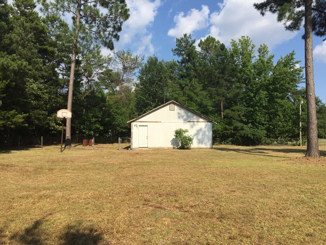 296 Juniper Creek Road Byron, GA 31008 - Photo 20 of 22 a view of large trees with wooden fence