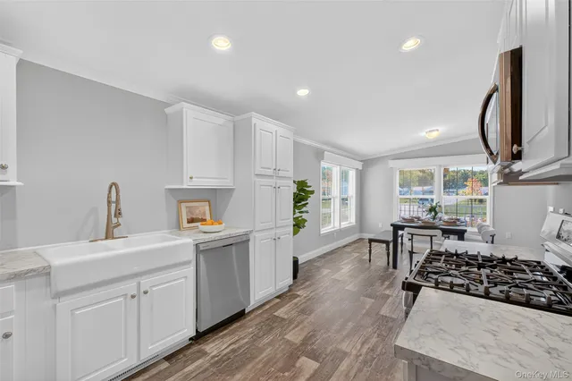 a kitchen with a sink a stove a microwave and cabinets