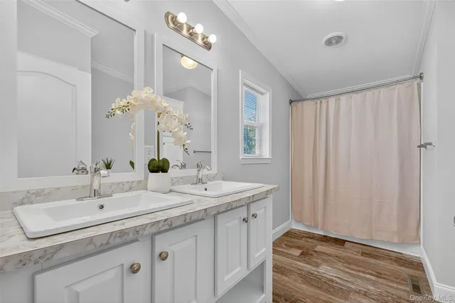a bathroom with a double vanity sink and a mirror