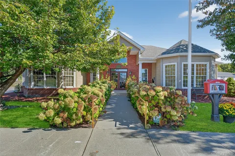 front view of a house with a garden