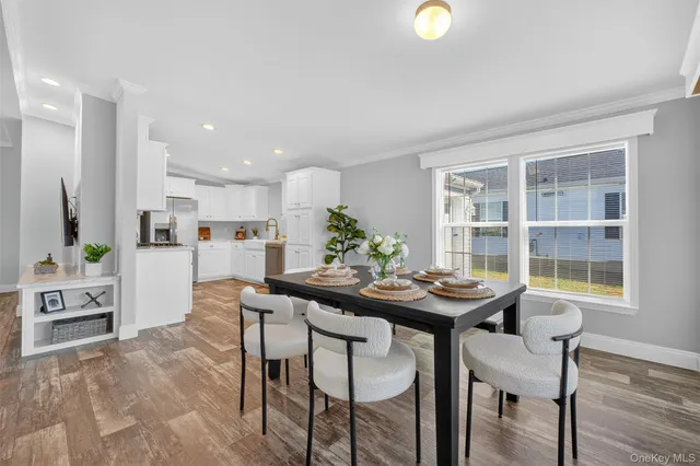 a view of a dining room with furniture and a potted plant